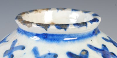 Lot 879 - A Persian pottery blue and white vase, 19th...