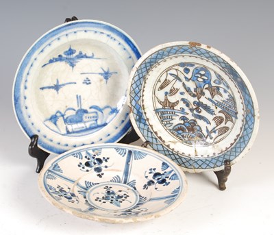 Lot 895 - Three Persian blue and white pottery dishes,...