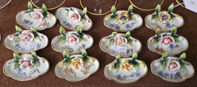 Lot 19 - Twelve porcelain flower encrusted quatrefoil...