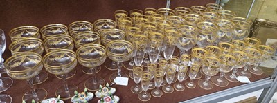 Lot 20 - A part suite of clear and gilded glassware,...