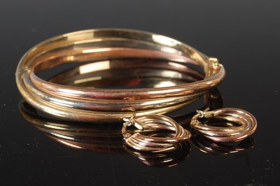 Lot 63 - A 9ct tri-colour gold hinged bangle; together...