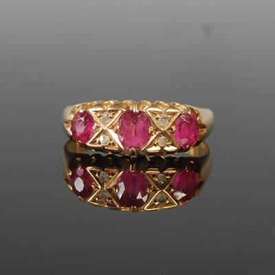 Lot 90 - An 18ct gold, ruby and diamond chip dress ring,...