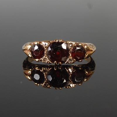 Lot 93 - A 9ct gold, garnet and diamond chip ring, size...