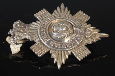 Lot 142 - A white metal cap badge for the Royal...