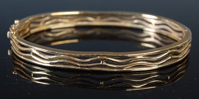 Lot 204 - A 9ct gold hinged bangle, 14.9 grams.