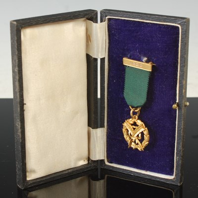 Lot 231 - A 9ct gold medal on green ribbon, with bar...