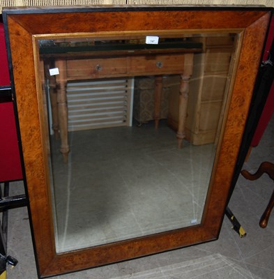 Lot 747 - A walnut and ebonised bevelled wall mirror.