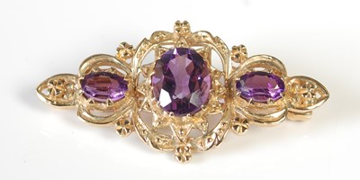 Lot 285 - A 9ct gold and three stone amethyst brooch, 36....