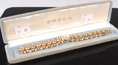 Lot 308 - A ladies 18ct gold bracelet watch by Omega,...