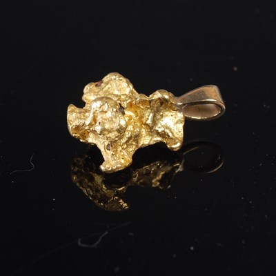 Lot 312 - A gold nugget mounted as a pendant, gross...