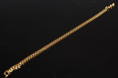 Lot 314 - A yellow metal bracelet stamped '18k', 9.3 grams.