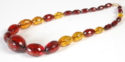 Lot 326 - A red and yellow amber type faceted graduated...