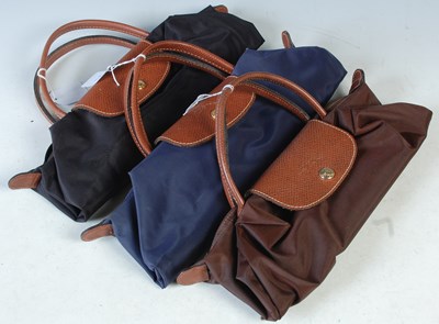 Lot 367 - Three Longchamp rollable handbags, black, blue...