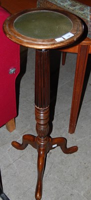 Lot 748 - A mahogany torchere with green leatherette top.