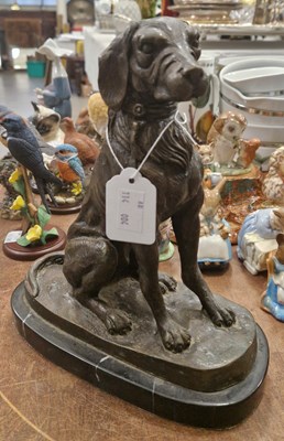 Lot 558 - A 20th century bronze figure of a seated dog,...