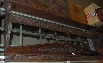 Lot 761 - A floral carved oak wall-mounted plate rack.