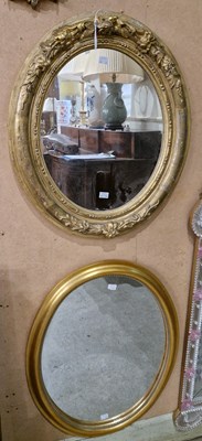 Lot 756 - A gilt framed oval wall mirror with fruit and...