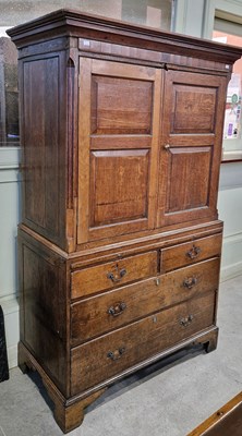 Lot 810 - An antique oak two-part cupboard, the upper...