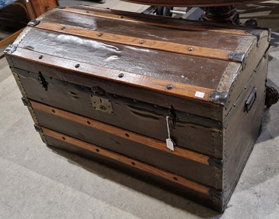 Lot 811 - A wood and brass bound dome top trunk, 92cm wide.