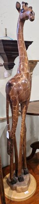 Lot 822 - A carved wooden model of a giraffe, 124cm high.