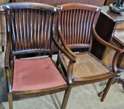 Lot 861 - A near pair of stained beech elbow chairs, one...