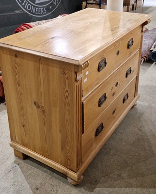 Lot 910 - A pine chest of three long drawers, enclosed...