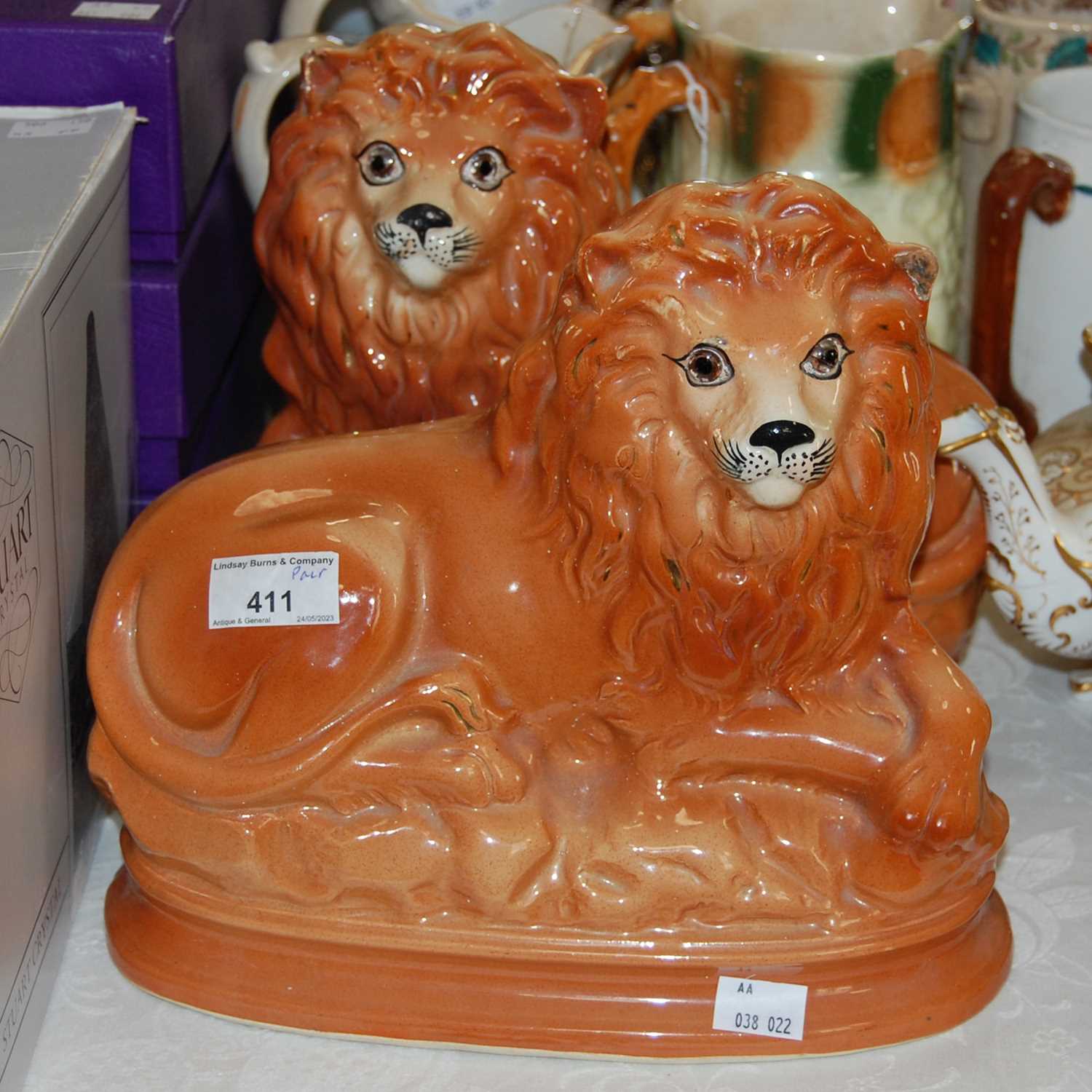 Lot 411 - A pair of Bo'ness pottery lions with inlaid...
