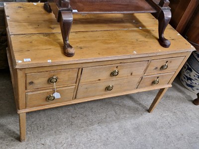 Lot 939 - A pine chest of five drawers, raised on four...