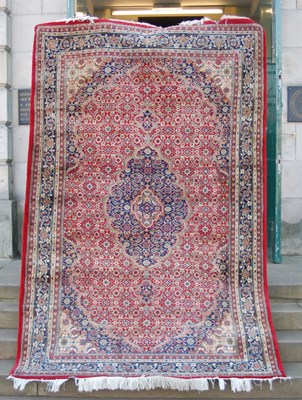 Lot 1002 - A 20th century Persian rug, the madder ground...