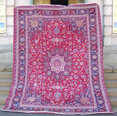 Lot 1016 - A Persian rug, 20th century, the madder ground...