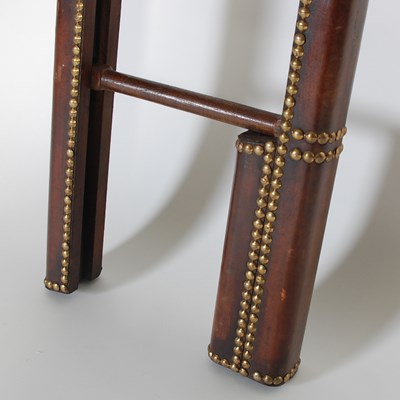 Lot 15 - A mahogany, leather and brass studded folding...
