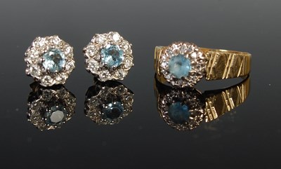 Lot 59 - An 18ct gold aquamarine and diamond cluster...