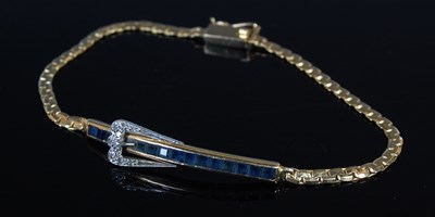 Lot 64 - An 18ct yellow and white gold, sapphire and...