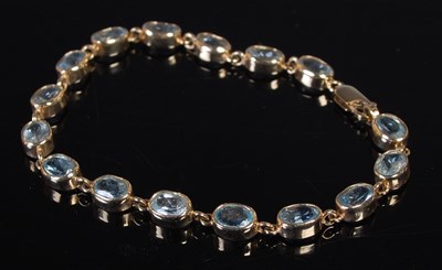 Lot 66 - A yellow metal and aquamarine bracelet,...