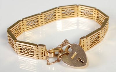 Lot 80 - A yellow metal gatelink bracelet with heart...