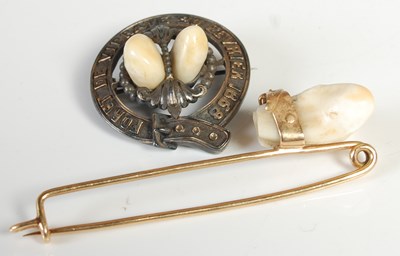 Lot 207 - A yellow metal brooch set with two teeth,...