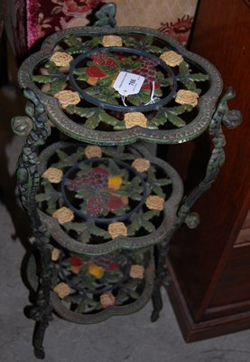 Lot 766 - A polychrome decorated cast metal three-tier...