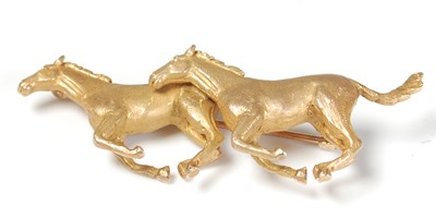 Lot 269 - A 9ct gold brooch modelled with two running...