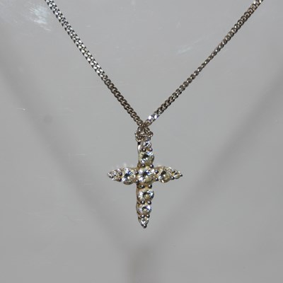Lot 276 - An 18ct white gold and diamond set cross...
