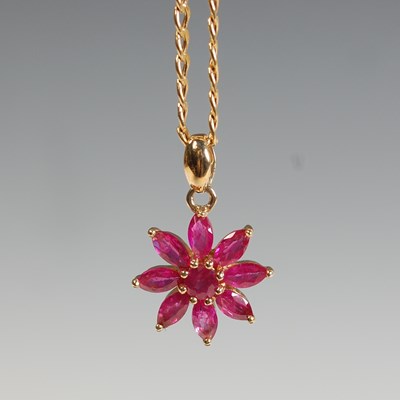Lot 283 - A 14ct gold and ruby flower pendant, suspended...