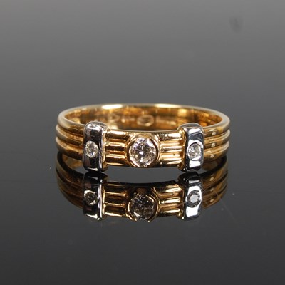Lot 284 - A yellow and white metal three stone diamond...