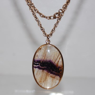 Lot 288 - A 9ct gold mounted Blue John oval pendant...