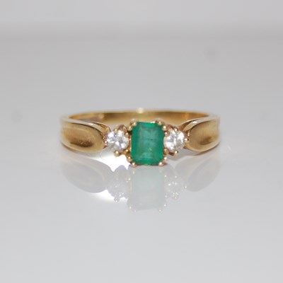 Lot 307 - An 18ct gold, emerald and diamond three stone...