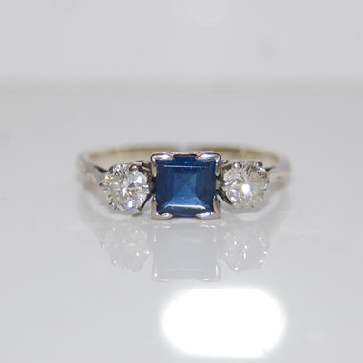 Lot 311 - A white metal, sapphire and diamond three...