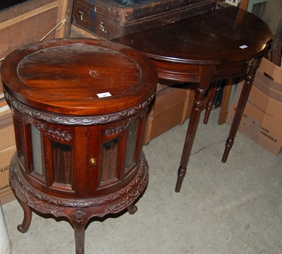 Lot 785 - A walnut circular drinks cabinet together with...