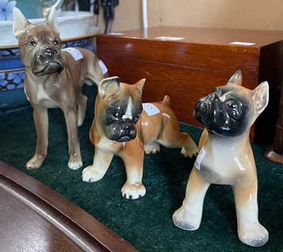 Lot 493 - Three assorted ceramic dog figures.