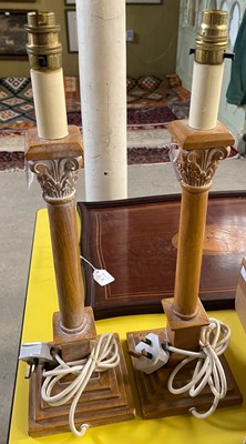 Lot 562 - A pair of carved wood Corinthian column table...