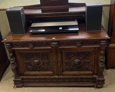 Lot 703 - A late 19th century stained oak sideboard, the...
