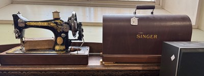 Lot 705 - A vintage Singer sewing machine in original...