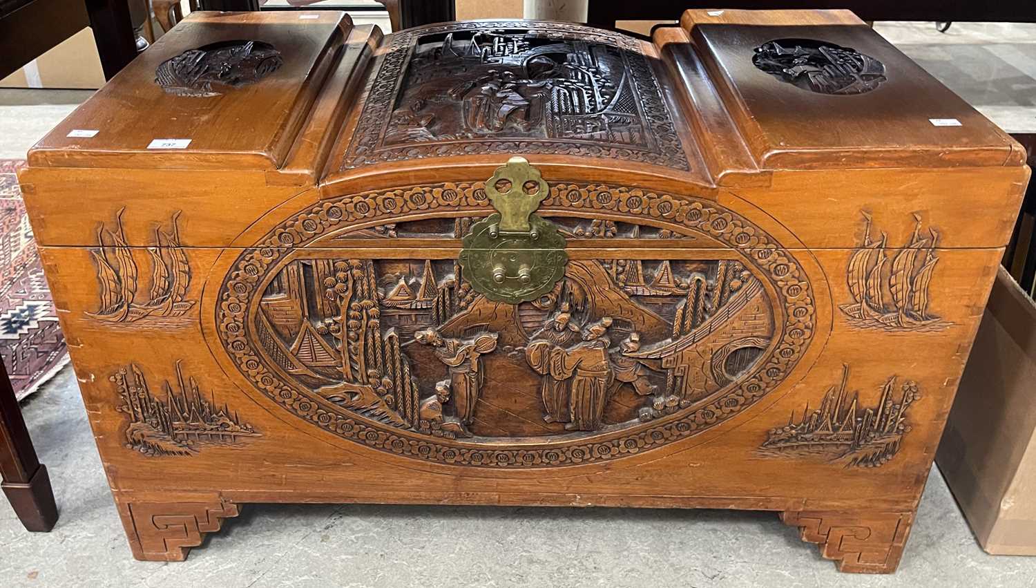 Lot 737 - A Chinese camphor wood box carved in shallow...